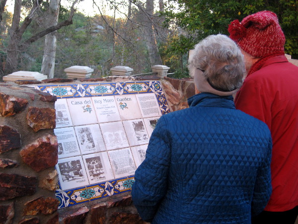 Visitors read about the history of the Casa del Rey Moro garden.