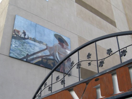 Mural high on side of building depicts Venetian gondoliers.