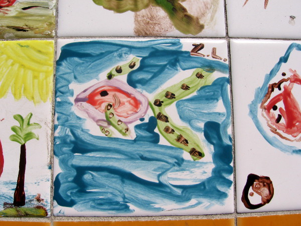 A tropical fish with long spotted green fins.