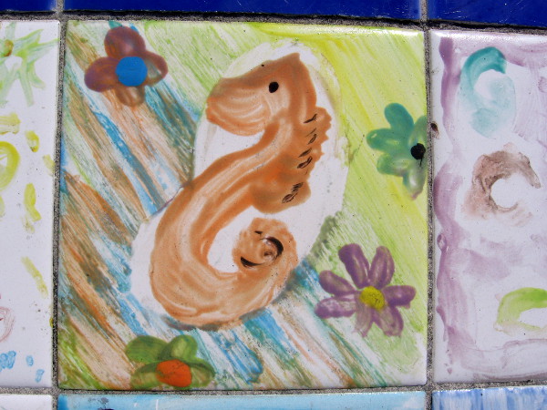 A very nicely rendered seahorse and colorful flowers.