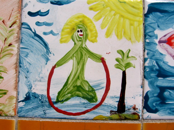 Here's a green mermaid jumping rope atop the blue ocean!