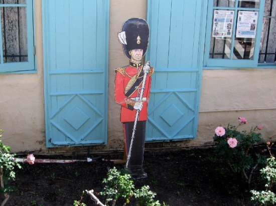Buckingham Palace Queen's Guard in front of the House of England cottage.