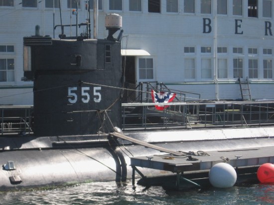 The black sail of submarine USS Dolphin (AGSS-555). The retired research sub is docked next to steam ferry Berkeley of the Maritime Museum of San Diego.