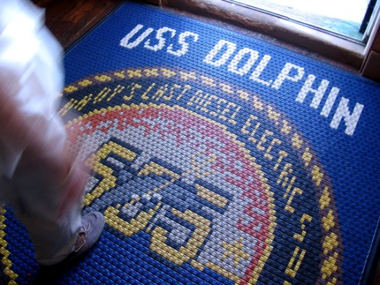 A museum visitor gets ready to walk out to a very cool submarine.