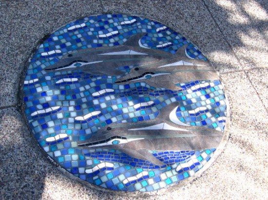 A pod of dolphins seems to be swimming down Pacific Coast Highway.