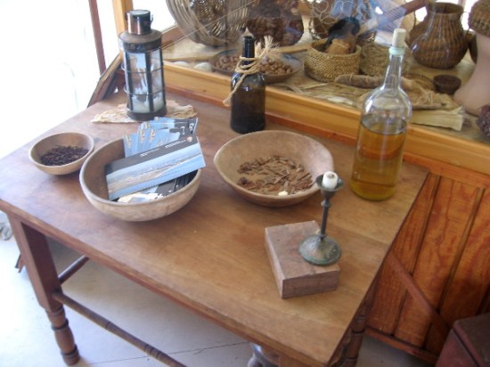 Various items on display include lantern, candle, bottle, ship's food and native Kumeyaay artifacts.