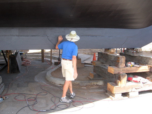 Volunteer tour guide shows how six segments of heavy lead are attached to the keel.