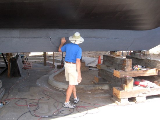 Volunteer tour guide shows how six segments of heavy lead are attached to the keel.