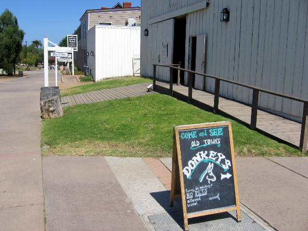 Walking through Old Town San Diego State Historic Park we see a sign near Seeley Stable Museum. Let's go see the donkeys!