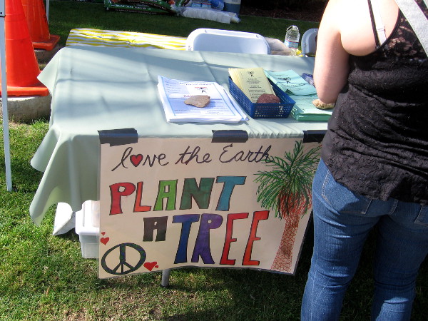 One many signs with environmental messages... love the Earth. Plant a tree.