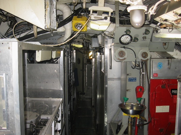 Starting along the very narrow main hallway. This unusual sub contains no compartments. To the left one can see a reverse osmosis water filtration system.
