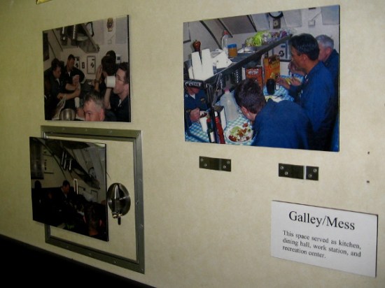 Photos on wall of tiny mess area show what life was like aboard Dolphin.