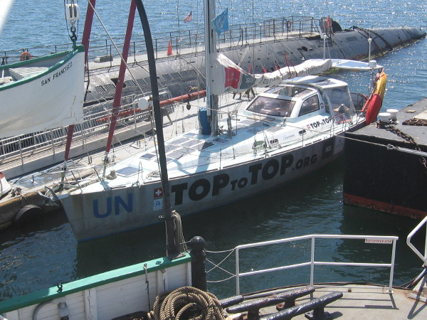 TOPtoTOP, docked by other museum ships, is equipped with many solar panels. It's sailing around the globe using only human and natural power sources.