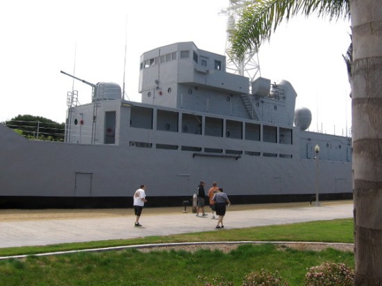 People walk past the newly painted USS Recruit near Liberty Station.