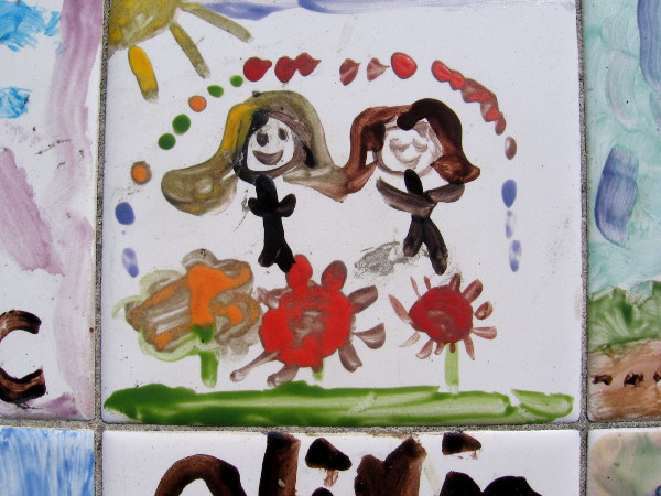 Two happy figures seem to jump above flowers.