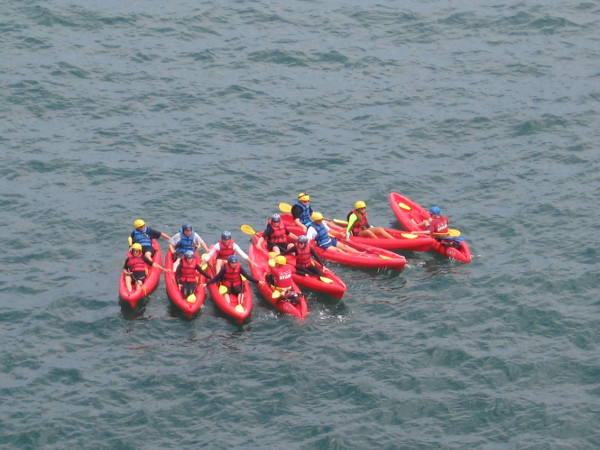 Red kayaks bunched close together below, east of Goldfish Point.