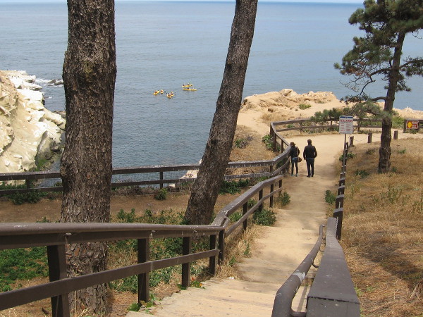 Wooden steps plunge down to a scenic view point atop amazing sandstone cliffs. In the narrow cove on the left is an entrance to a sea cave.