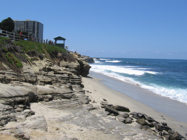 Looking south along the narrow beach from Point La Jolla. One of many lookout structures is visible up on the cliff.
