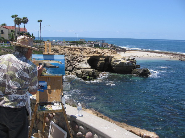 An artist paints a beautiful scene in a cozy view point not far from Children's Pool.