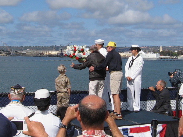 In a time-honored ritual and tribute, the first wreath takes flight as many watch.