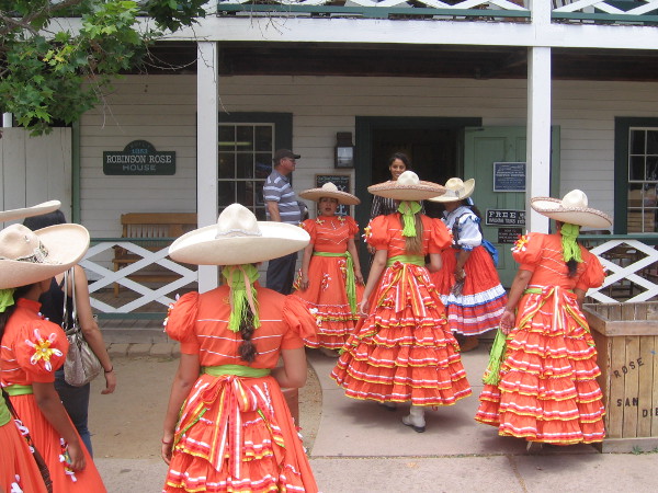 Ladies in Mexican folk costume gather in front of Old Town's Robinson-Rose House.