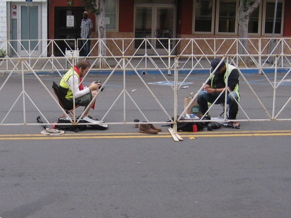 Some photographers sit idle, waiting for the race to come their way.