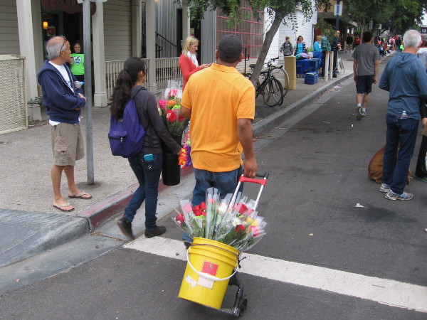Meanwhile, flowers are being sold to onlookers beside the race route.