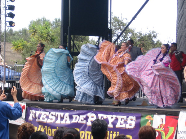 Traditional Mexican folk dancers in long flowing skirts dazzle the big crowd.