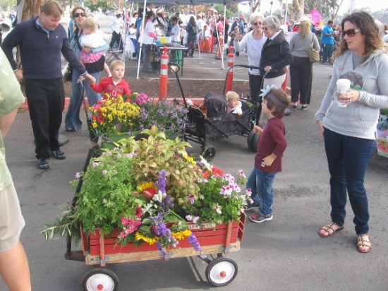The floral wagon parade staged in a parking lot by the Balboa Park carousel.