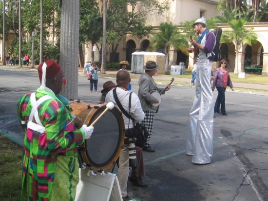 Other performers from the Fern Street Circus wait a bit further down the parade route for the spectacle to begin.