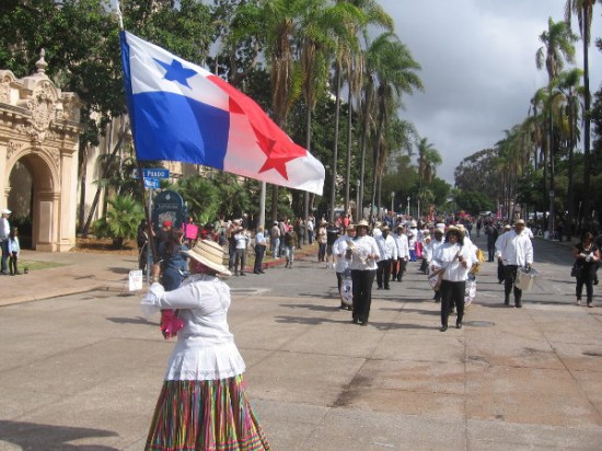 Here come drummers and a flag down the festive parade route!