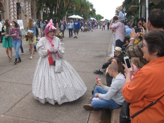 This lady in an elegant old-fashioned dress was handing out goodies to the watching crowd.