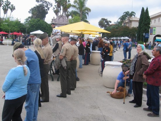 Civilian and military bystanders look on as a memorable San Diego event is taking place.