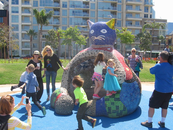 Kids play on a newly installed fat hollow Cat. The interactive sculpture sits next to the playground in San Diego's super cool, one-year-old waterfront park!