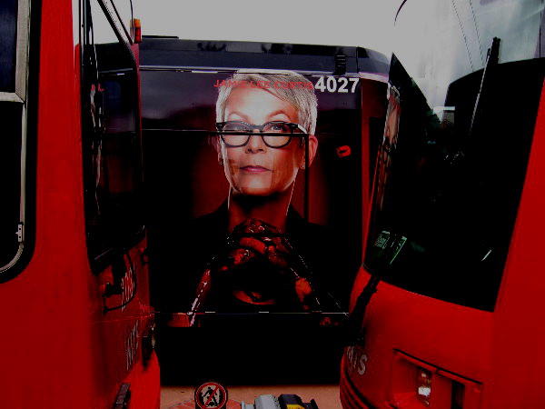 A bloody-handed Jamie Lee Curtis peers between trolley cars at me! Yikes!