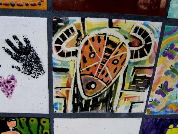 Exotic mask with horns painted on a tile.