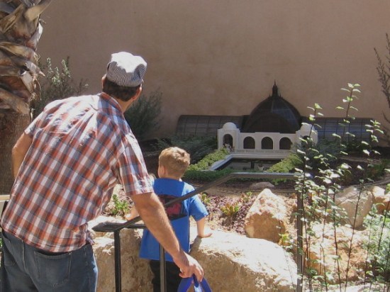 Young and old together dream in a small outdoor nook in Balboa Park.