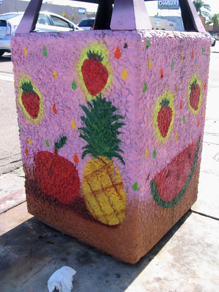 Pineapple, fresh strawberries, watermelon, and some litter.