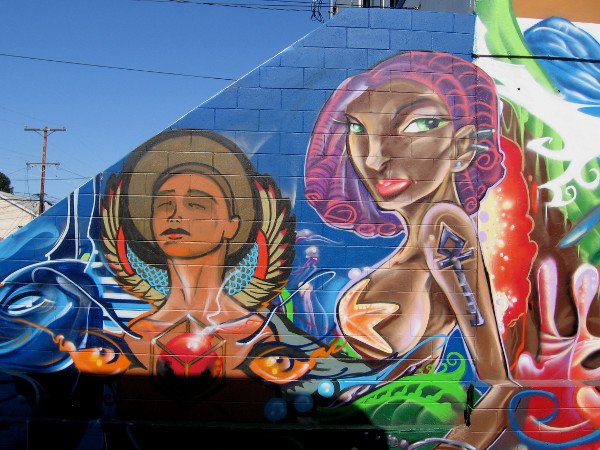 Stylish figures on wall leading from alley to parking lot of The Merrow and Tabletop Commons.