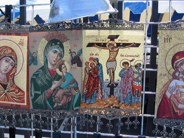 Orthodox religious icons displayed by one tent include familiar Christian symbols.