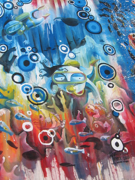 A scuba diver among bubbles and rays of colored light.