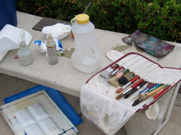 Brushes wait on a nearby bench.