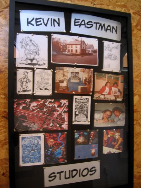 Images in one display show some work of comic artist Kevin Eastman and the studio where he has worked.