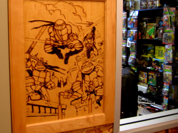 Wood panel by studio window shows the four funny, dynamic turtles in action.
