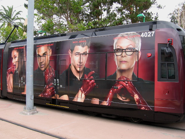 Faces of Scream Queens on a San Diego trolley include Ariana Grande, Lucien Laviscount and Nick Jonas.