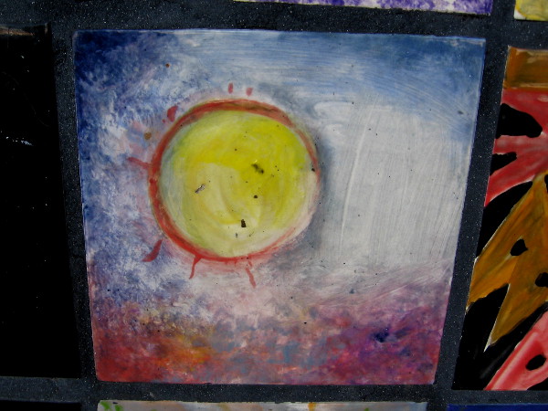 A sun painted on a tinted sky.