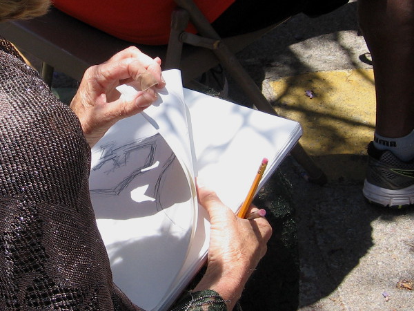 A carefully watching artist has made a few sketches during the performance in Spanish Village.