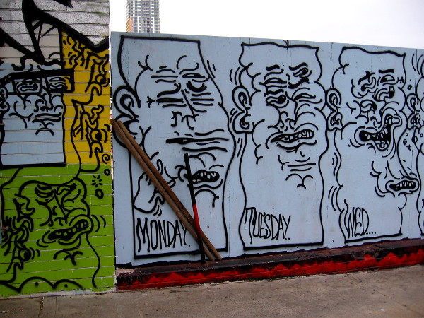 Graffiti faces are all squinched up on the wall between SILO in Makers Quarter and F Street in East Village.