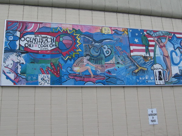 Public art mural on one wall depicts the annual Ocean Beach Street Fair and Chili Cook-Off.