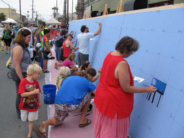 Anyone could participate in painting a small square in this large mural!